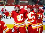 Lindholm shines for Flames with a pair of goals in 7-4 win over Canucks